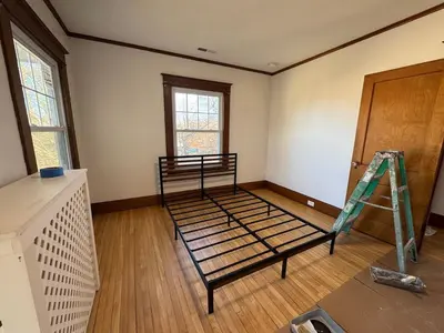 an empty room with a bed in a room at Warm and Cozy 4Bd 2Bath in Southington