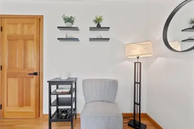 a living room with a chair and a lamp at 40 Spacious Sleek Cozy in Middletown