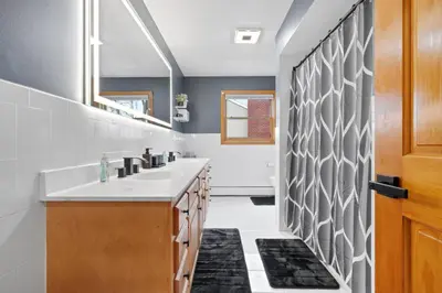 a bathroom with a sink and a mirror at 40 Spacious Sleek Cozy in Middletown