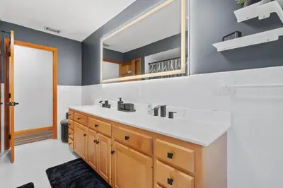 a bathroom with a sink and a mirror at 40 Spacious Sleek Cozy in Middletown