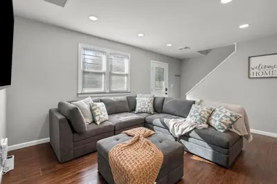 a living room with a couch and a chair at 22- 4 Br 2 Ba House - Central CT in New Britain