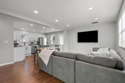 a living room with a couch and a kitchen at 22- 4 Br 2 Ba House - Central CT in New Britain