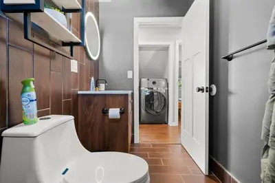 a bathroom with a toilet and a washing machine at 22- 4 Br 2 Ba House - Central CT in New Britain