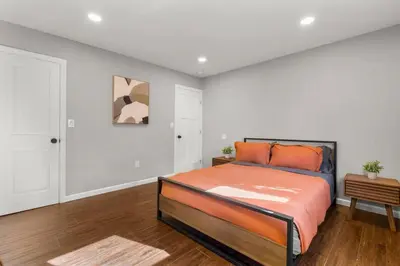 a bedroom with a bed with an orange blanket at 22- 4 Br 2 Ba House - Central CT in New Britain