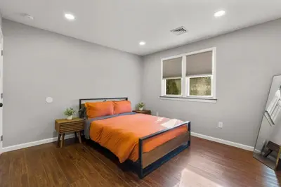 a bedroom with a bed and two windows at 22- 4 Br 2 Ba House - Central CT in New Britain