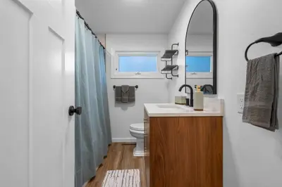 a bathroom with a sink and a toilet and a mirror at 27- Luxury Collection in Southington