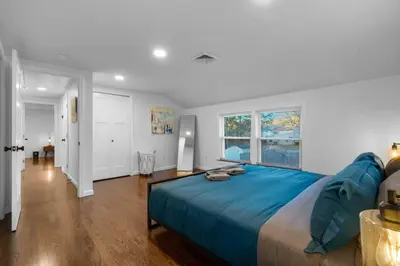 a bedroom with a large bed with blue sheets at 27- Luxury Collection in Southington