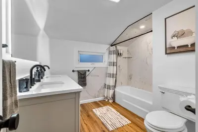 a bathroom with a sink and a toilet and a tub at 27- Luxury Collection in Southington