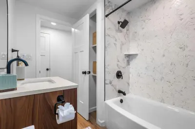 a white bathroom with a tub and a sink at 27- Luxury Collection in Southington