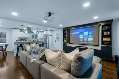 a living room with a couch and a flat screen tv at 27- Luxury Collection in Southington