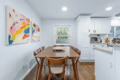 a dining room with a wooden table and chairs at 27- Luxury Collection in Southington