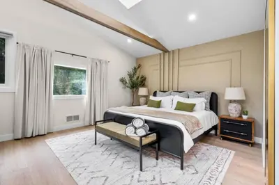 a bedroom with a large bed and a rug at 37 - Luxury Collection in Stratford
