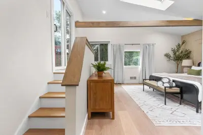 a living room with a bed and a stairway at 37 - Luxury Collection in Stratford