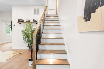 a staircase in a home with white walls and wooden floors at 37 - Luxury Collection in Stratford