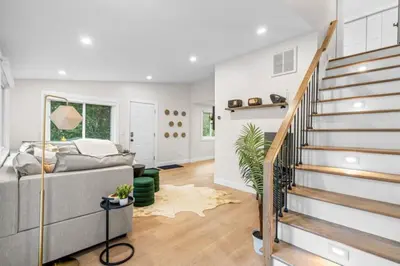 a living room with a staircase and a couch at 37 - Luxury Collection in Stratford
