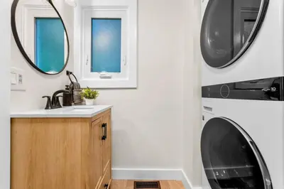 a bathroom with a sink and a washing machine at 37 - Luxury Collection in Stratford