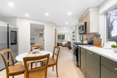 a kitchen with a table and chairs and a dining room at 37 - Luxury Collection in Stratford