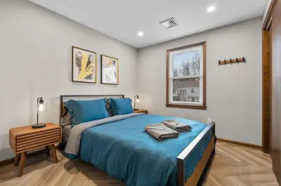 a bedroom with a blue bed and a window at 29 - Modern 5 Bedroom 2 Bath in Middletown