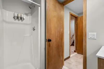 a bathroom with a shower and a door to a hallway at 29 - Modern 5 Bedroom 2 Bath in Middletown