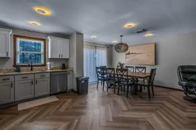 a kitchen and dining room with a table and chairs at 29 - Modern 5 Bedroom 2 Bath in Middletown