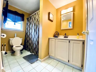 a bathroom with a toilet and a sink at 16 A COZY GETAWAY 4BED 3BATH HOME W FIRE PIT in Southington