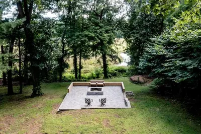a picnic table in a field with two benches at 16 A COZY GETAWAY 4BED 3BATH HOME W FIRE PIT in Southington