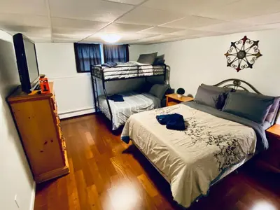 a bedroom with a bed and a bunk bed at 16 A COZY GETAWAY 4BED 3BATH HOME W FIRE PIT in Southington