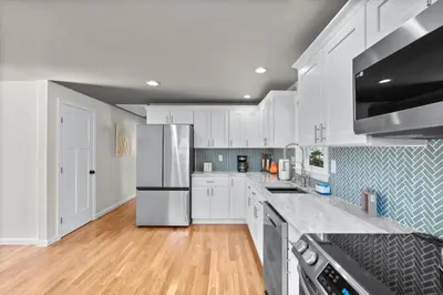 a kitchen with white cabinets and stainless steel appliances at 26 Beautifully Renovated 2 BR Home in Plainville