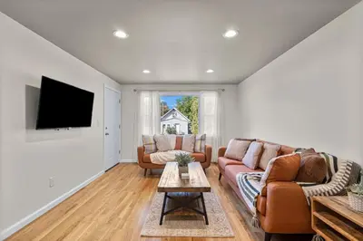 a living room with two couches and a tv at 26 Beautifully Renovated 2 BR Home in Plainville