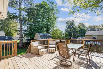 a patio with a table and chairs on a deck at 26 Beautifully Renovated 2 BR Home in Plainville