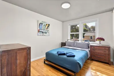 a bedroom with a bed and a dresser and a window at 26 Beautifully Renovated 2 BR Home in Plainville