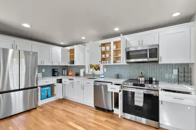 a kitchen with white cabinets and stainless steel appliances at 26 Beautifully Renovated 2 BR Home in Plainville