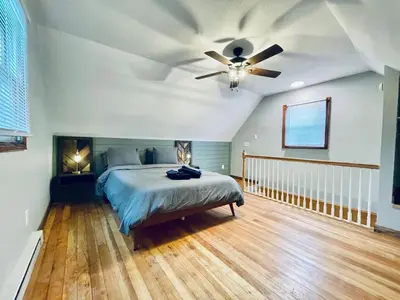 a bedroom with a bed and a ceiling fan at 24 Serenity A Lakefront Cottage Retreat in Middletown