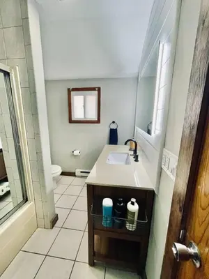 a bathroom with a sink and a toilet at 24 Serenity A Lakefront Cottage Retreat in Middletown