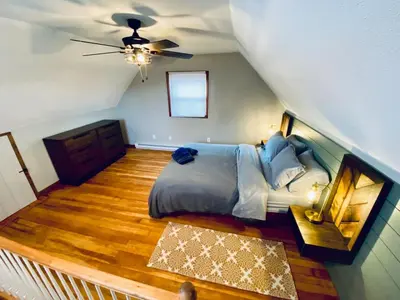 a bedroom with a bed and a ceiling at 24 Serenity A Lakefront Cottage Retreat in Middletown