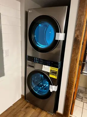 a washing machine and a dryer in a room at 24 Serenity A Lakefront Cottage Retreat in Middletown