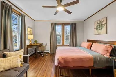 a bedroom with a bed and a ceiling fan at 25 Massive 5 BR in Downtown Southington in Southington