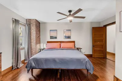 a bedroom with a bed and a ceiling fan at 25 Massive 5 BR in Downtown Southington in Southington
