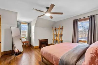 a bedroom with a bed and a ceiling fan at 25 Massive 5 BR in Downtown Southington in Southington