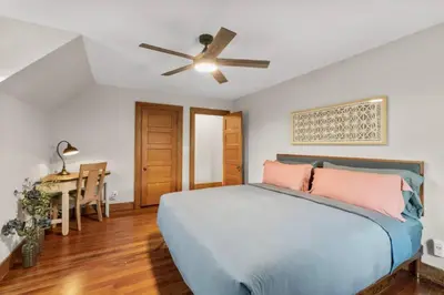 a bedroom with a bed and a ceiling fan at 25 Massive 5 BR in Downtown Southington in Southington