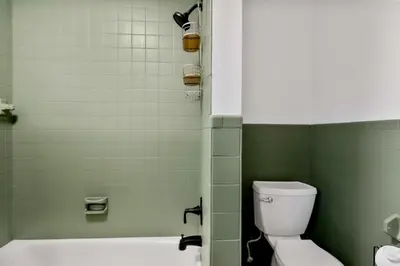 a bathroom with a tub and a toilet and a shower at 25 Massive 5 BR in Downtown Southington in Southington