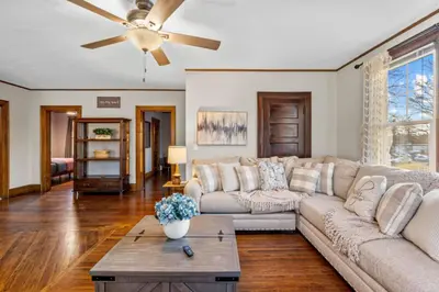 a living room with a couch and a ceiling fan at 25 Massive 5 BR in Downtown Southington in Southington