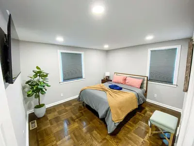 a bedroom with a bed and two windows at 21 COMFORTABLE AND LUXURIOUS in Plainville