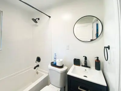 a bathroom with a sink and a toilet and a mirror at 21 COMFORTABLE AND LUXURIOUS in Plainville
