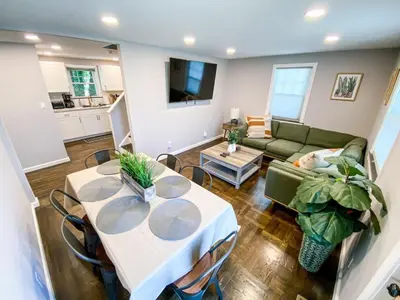 a living room with a table and a couch at 21 COMFORTABLE AND LUXURIOUS in Plainville