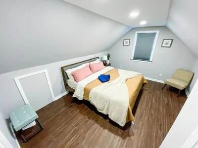 a bedroom with a bed with pink pillows at 21 COMFORTABLE AND LUXURIOUS in Plainville