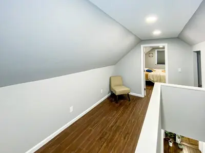 an empty room with a chair and a bedroom at 21 COMFORTABLE AND LUXURIOUS in Plainville