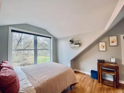 a bedroom with a bed and a large window at 23 COMFORT AND LUXURY 3 BR 2 BA House in Southington