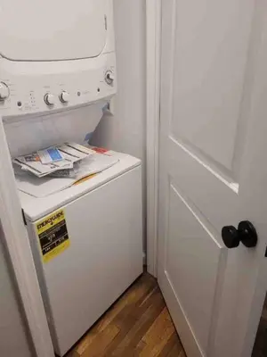 a white refrigerator in a kitchen with a door at 23 COMFORT AND LUXURY 3 BR 2 BA House in Southington