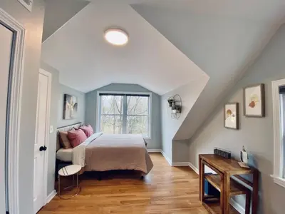 a bedroom with a bed and a window at 23 COMFORT AND LUXURY 3 BR 2 BA House in Southington
